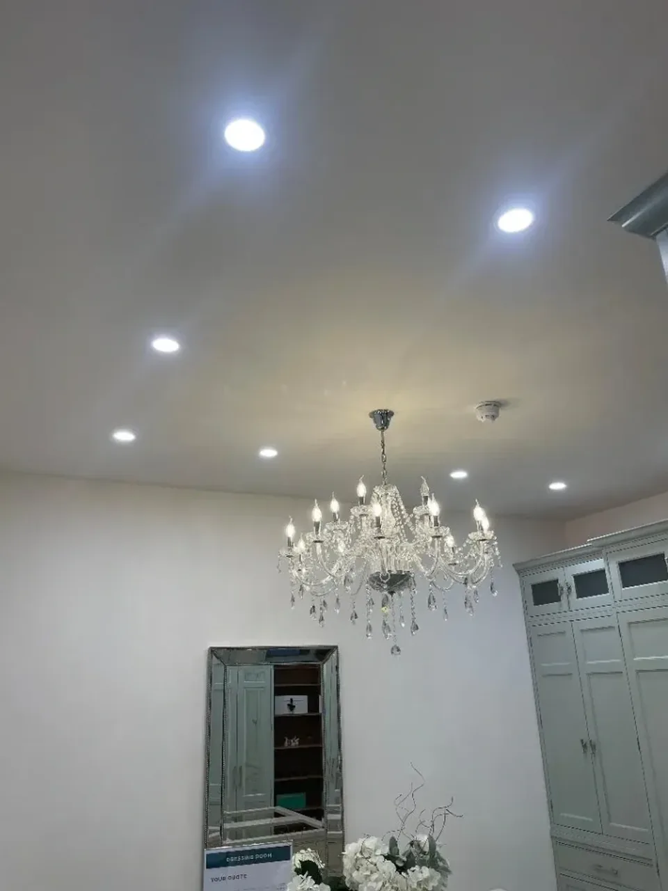 Crystal chandelier and spotlights installed in a kitchen showroom