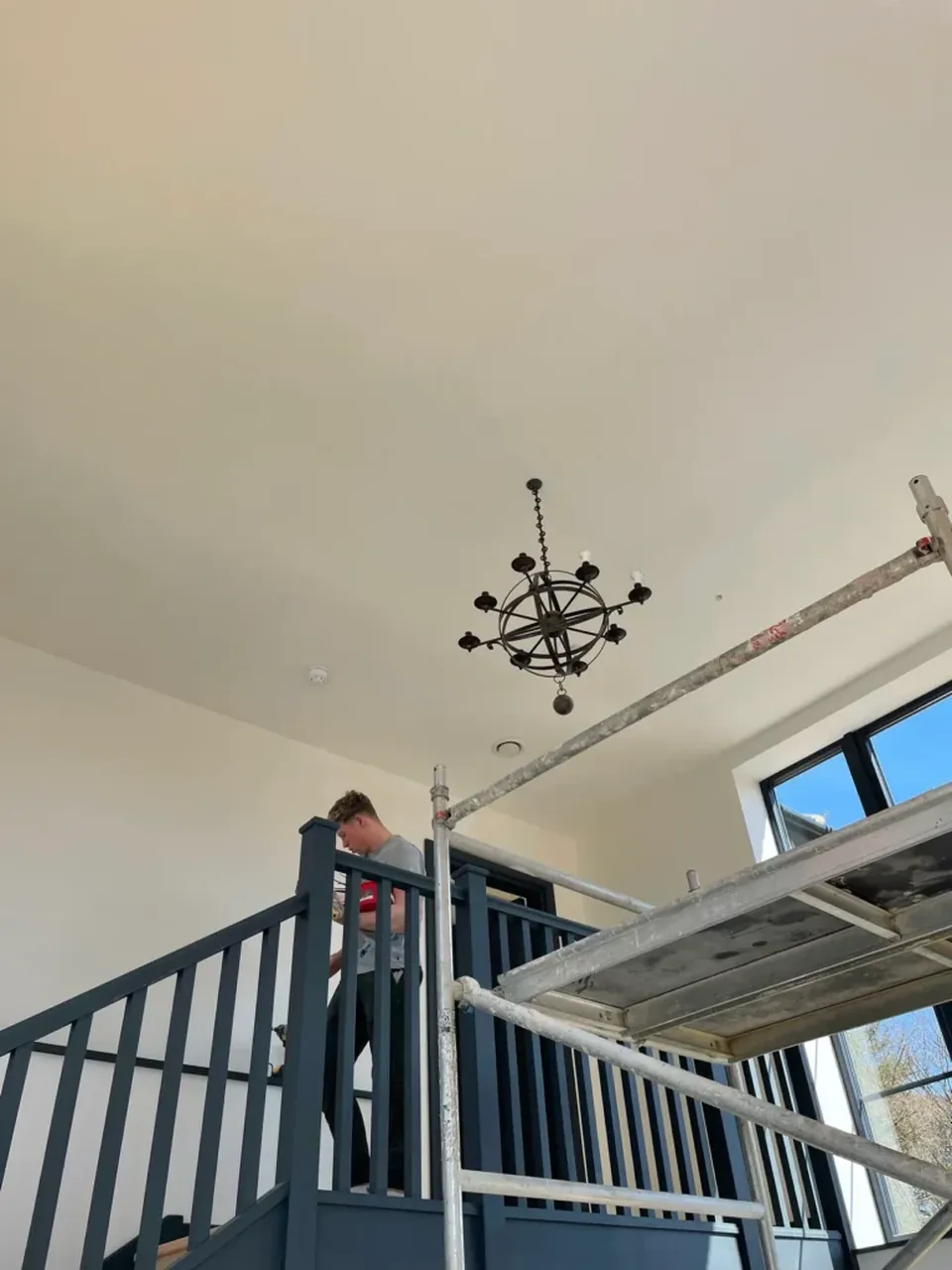 Chandelier installed on a staircase during a showroom fit-out
