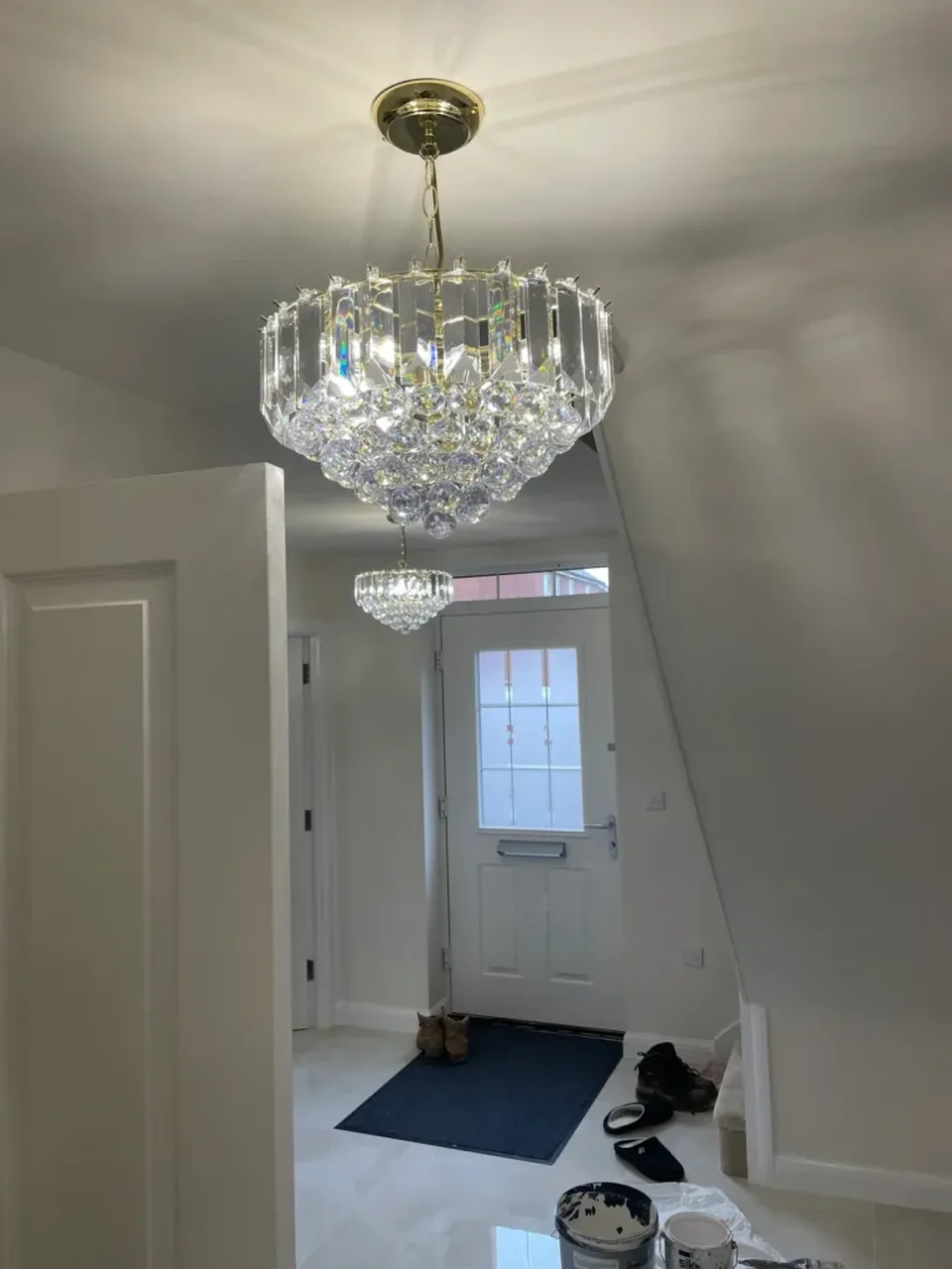 Chandelier installed in the entrance hallway of a new-build home